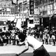 A rioter hurls a rock at police in Hong Kong, May 1967.